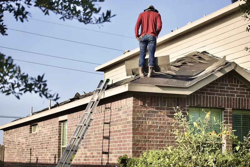 Professional roofer working on a residential roof in Seasons at Tradition